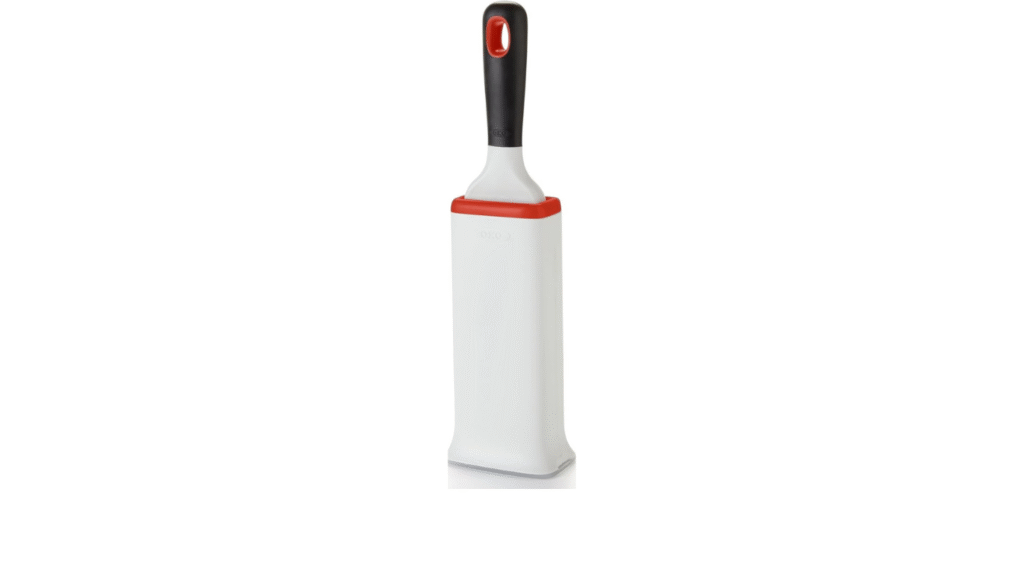 OXO Good Grips Furlifter Pet Garment Brush removing pet hair and lint from clothes and upholstery.