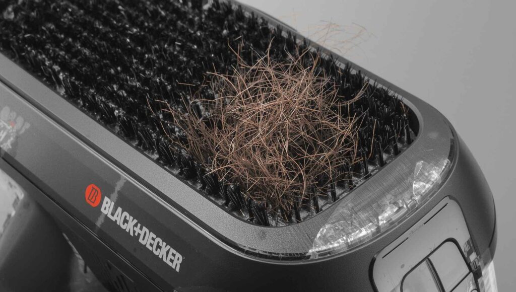 “Close-up of BLACK+DECKER Pet Hair Remover reusable fur cleaning brush.”