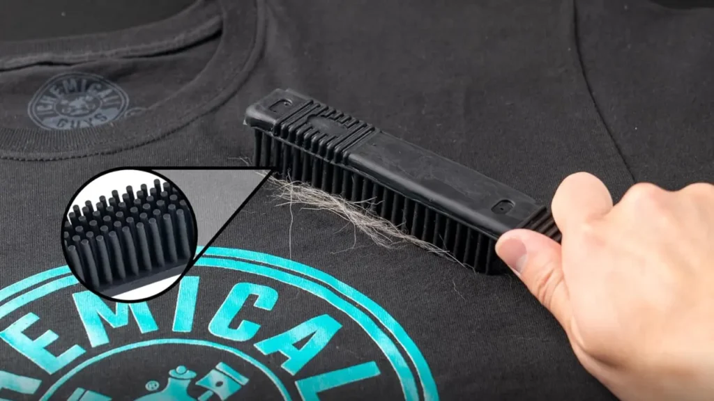 "Rubber Hair Removal Brush removing pet hair from shirt"