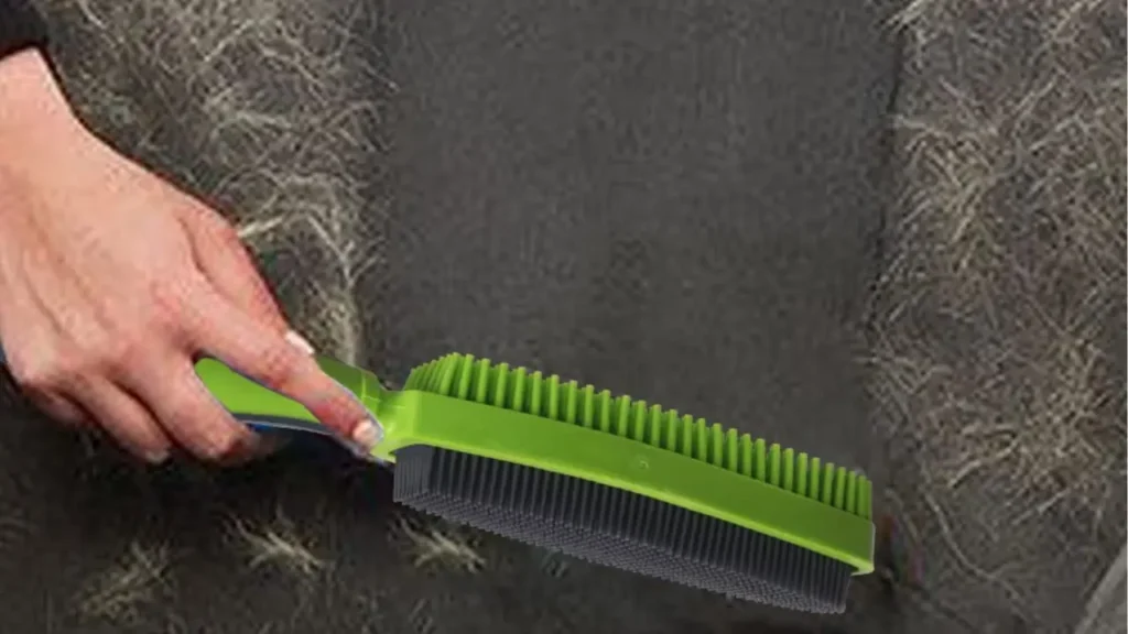 Close-up of removal brush bristles collecting pet hair from couch fabric.
